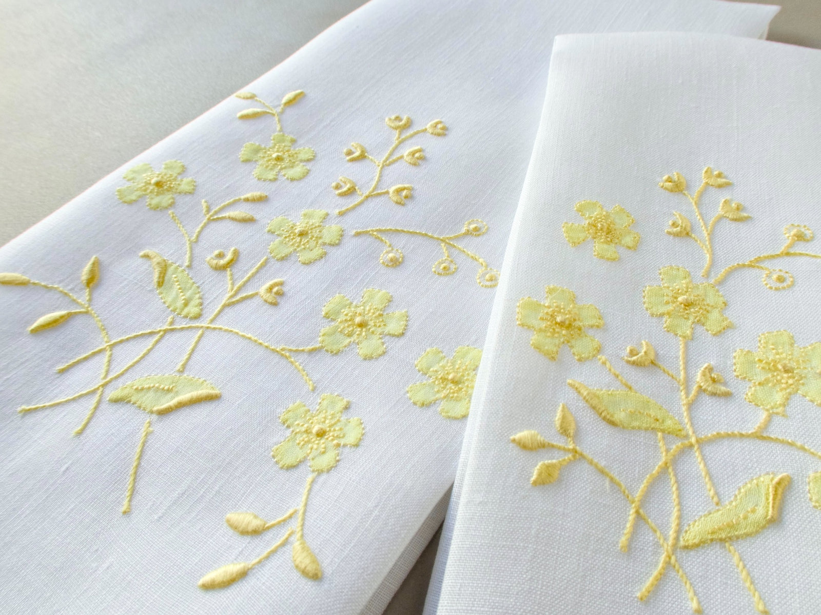 Vintage Marghab linen towels in the “Spray” pattern, hand embroidered in yellow on white linen.