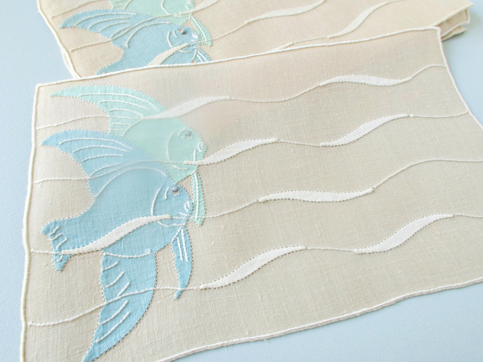 Vintage Madeira cocktail napkins, set of 8, blue and green angelfish appliqué and embroidery on cream linen with undulating wave design.