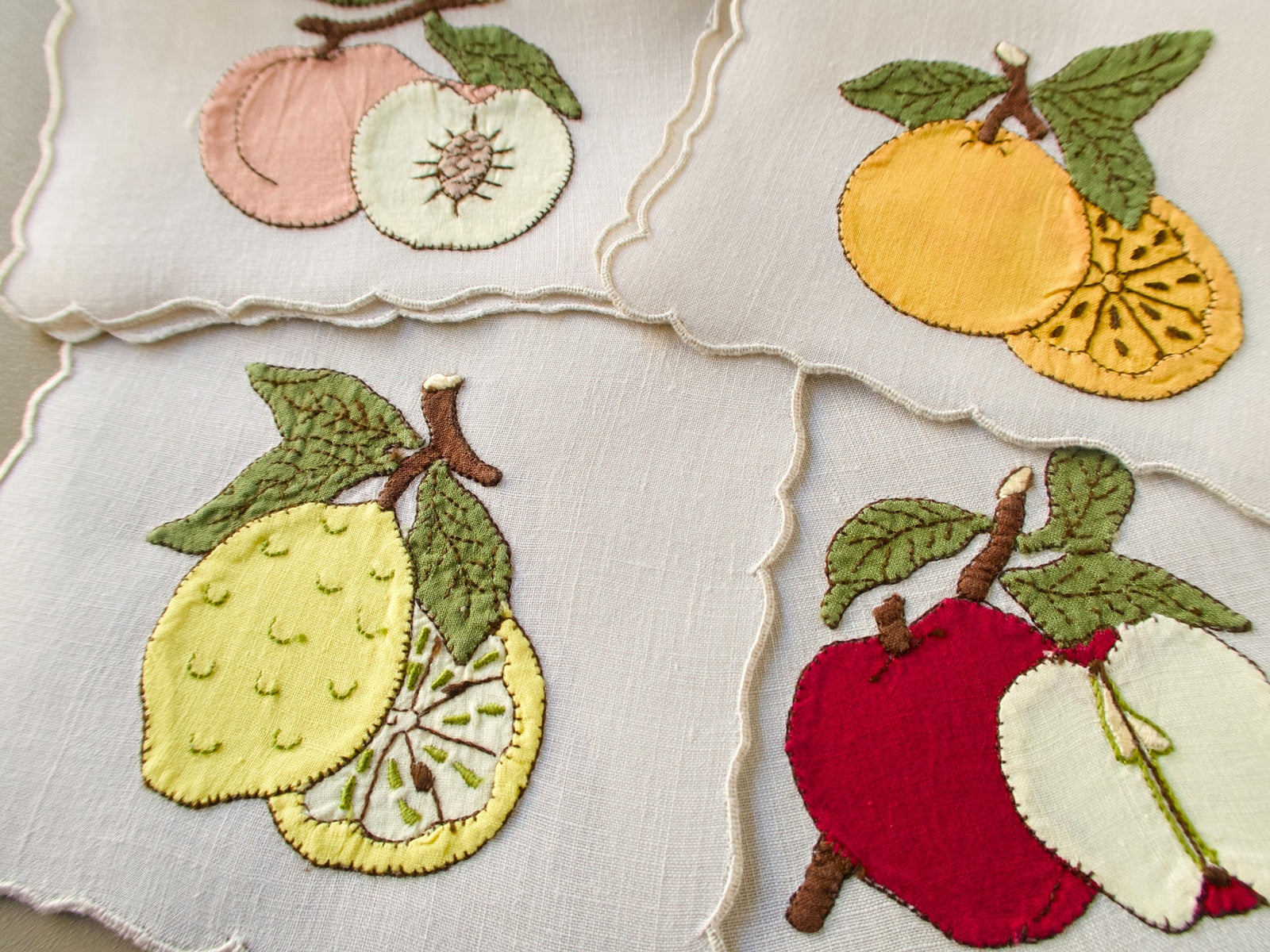 Vintage Madeira cocktail napkins with appliqué apple, lemon, orange and peach shown whole and sliced