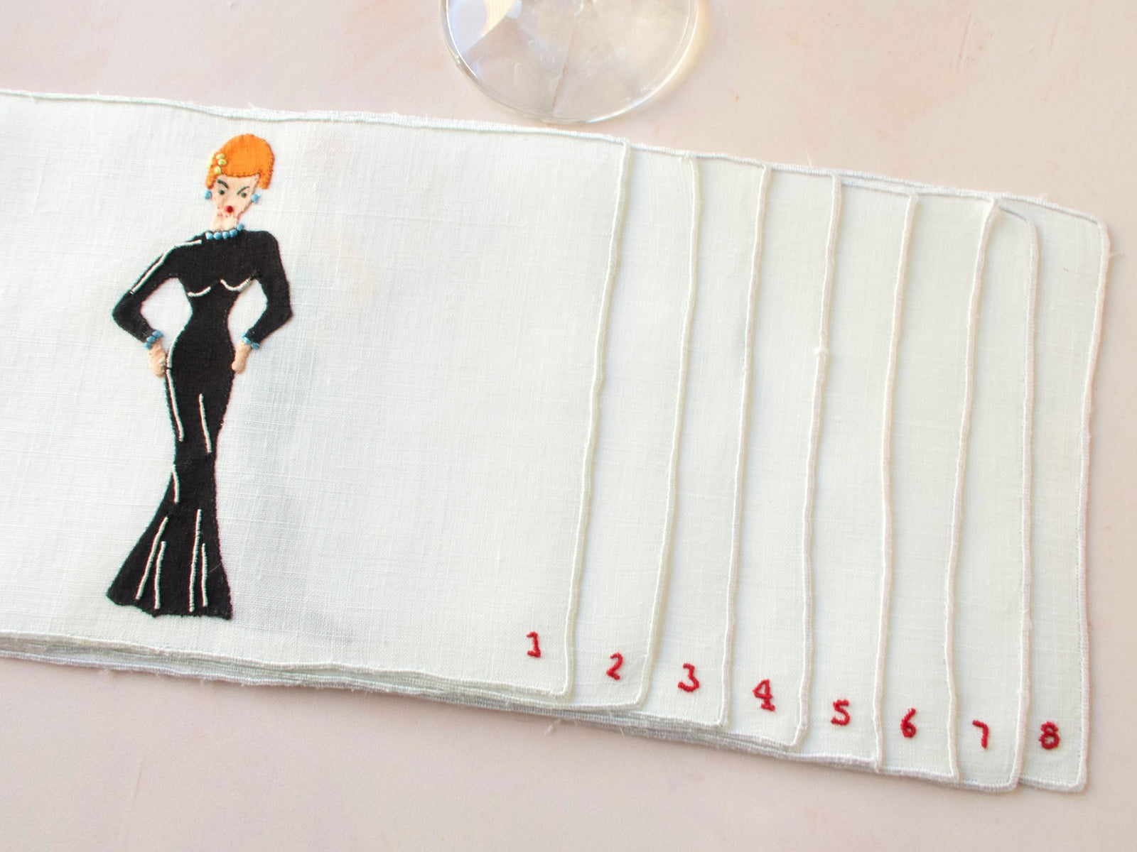 Unused vintage Madeira cocktail napkins featuring woman in black gown, hand embroidered mid-century linen