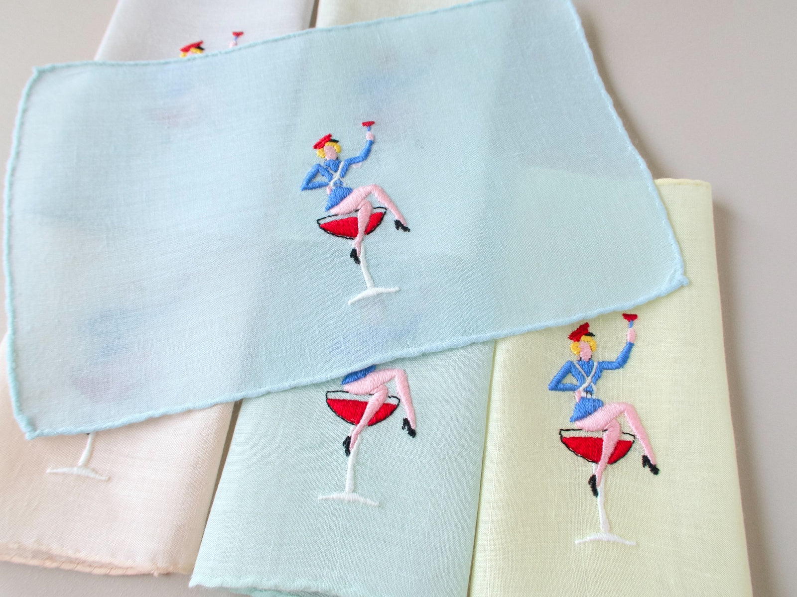 Close view of hand embroidered sailor figure on vintage Italian semi-sheer linen cocktail napkin, full color detail.