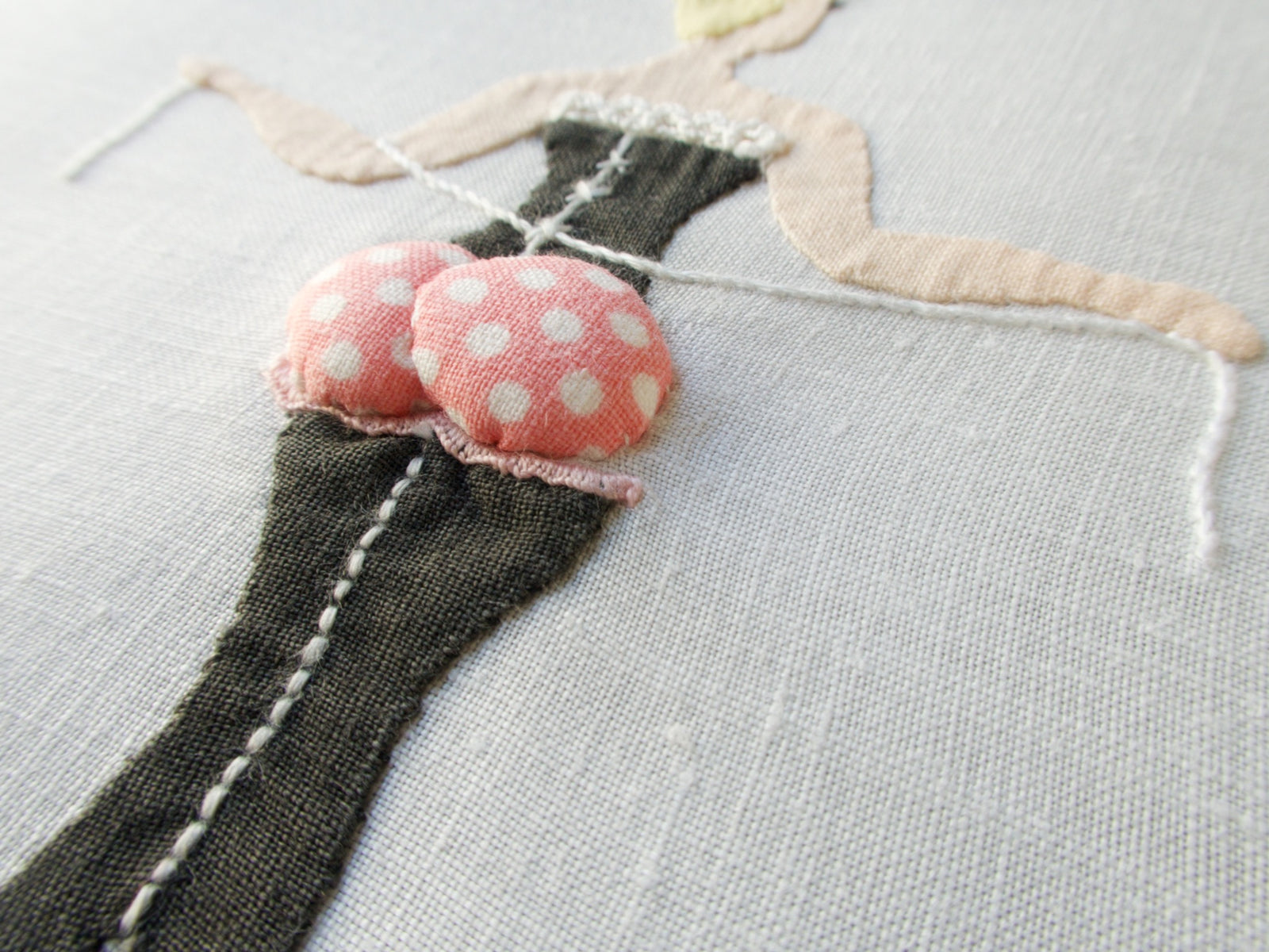 Close-up of vintage Madeira linen cocktail napkin by Paragon featuring playful hand-embroidered ladies with dimensional appliqué