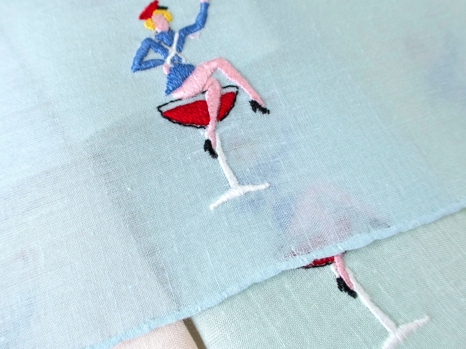 Detail of small opening in the weave at the edge of one napkin, vintage Italian embroidered linen cocktail napkin.