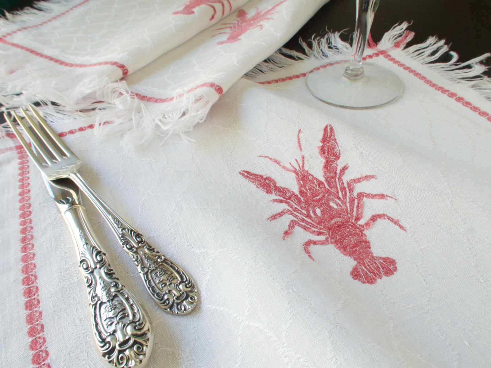 Antique French lobster damask napkins from Château de Kerguehennec, set of 12 with fringe, circa 1900, shown with silverware and wine glass