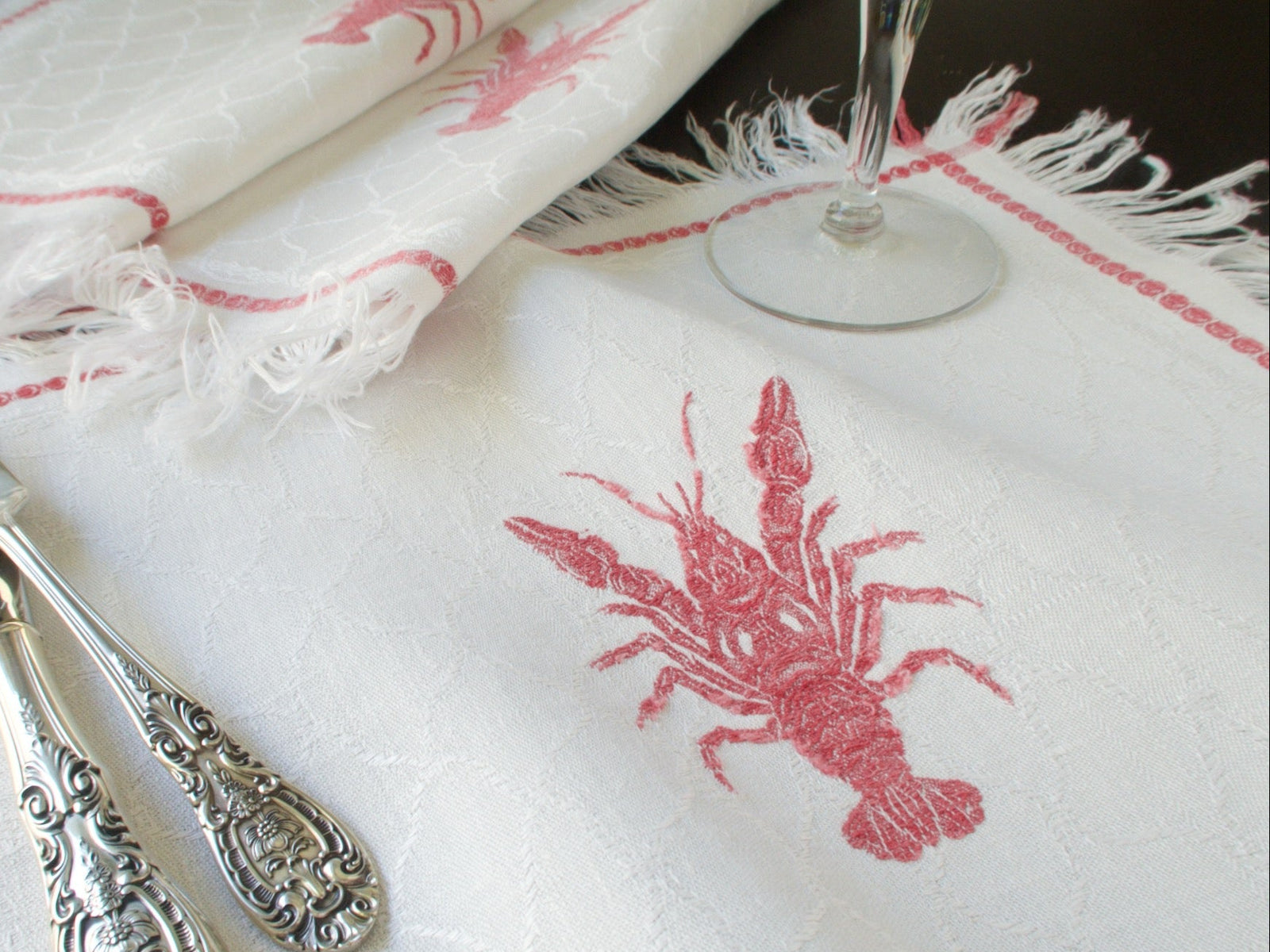Antique French lobster damask napkins from Château de Kerguehennec, set of 12 with fringe, circa 1900, shown with silverware and wine glass
