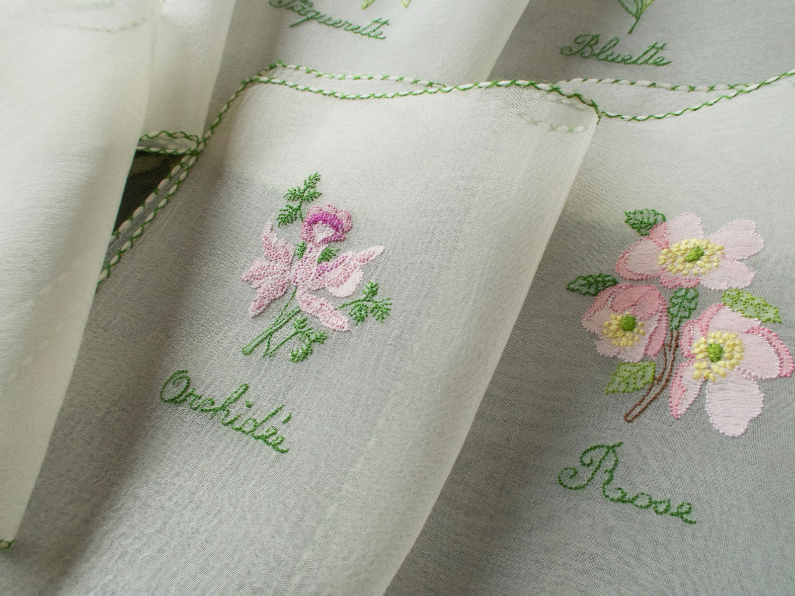 Vintage silk chiffon cocktail napkins hand embroidered with French flower names and delicate floral motifs.