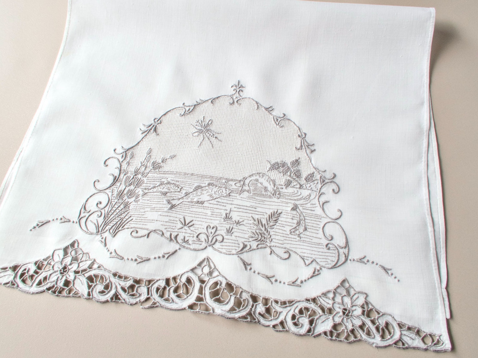 Antique Italian hand embroidered linen guest towel with fish motif.