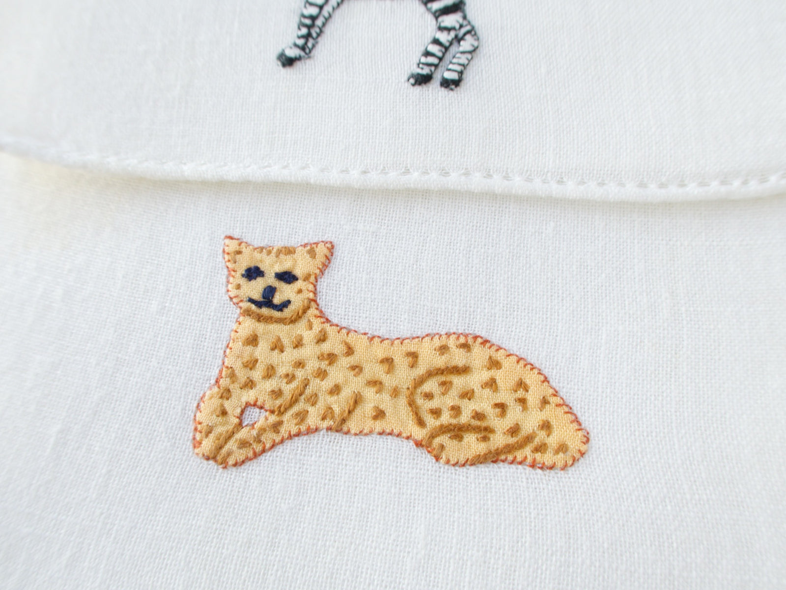 Vintage Italian cocktail napkin, detailed embroidered leopard lying down on white linen