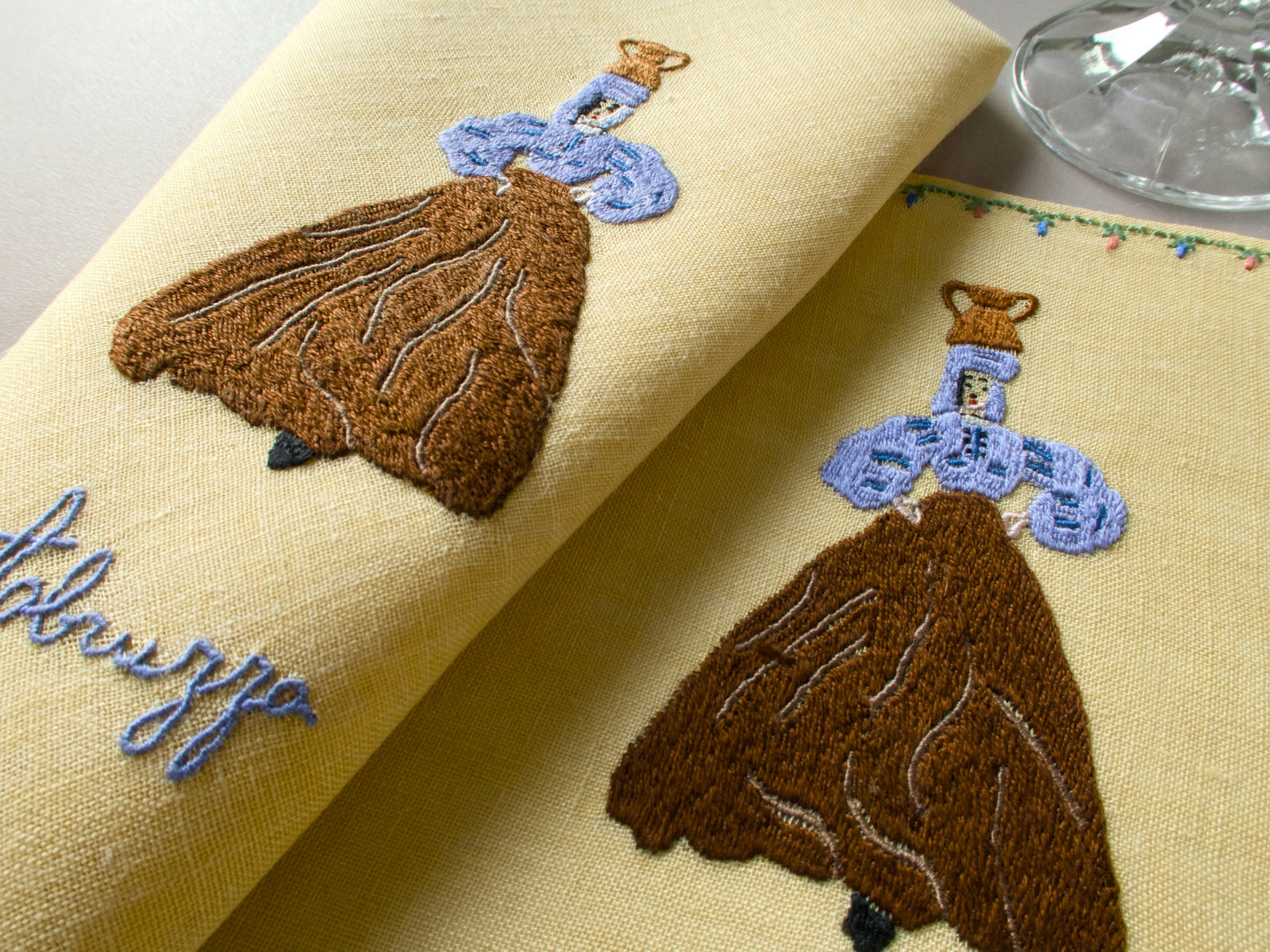 1. Rapisardi yellow linen napkin with embroidered woman in regional costume