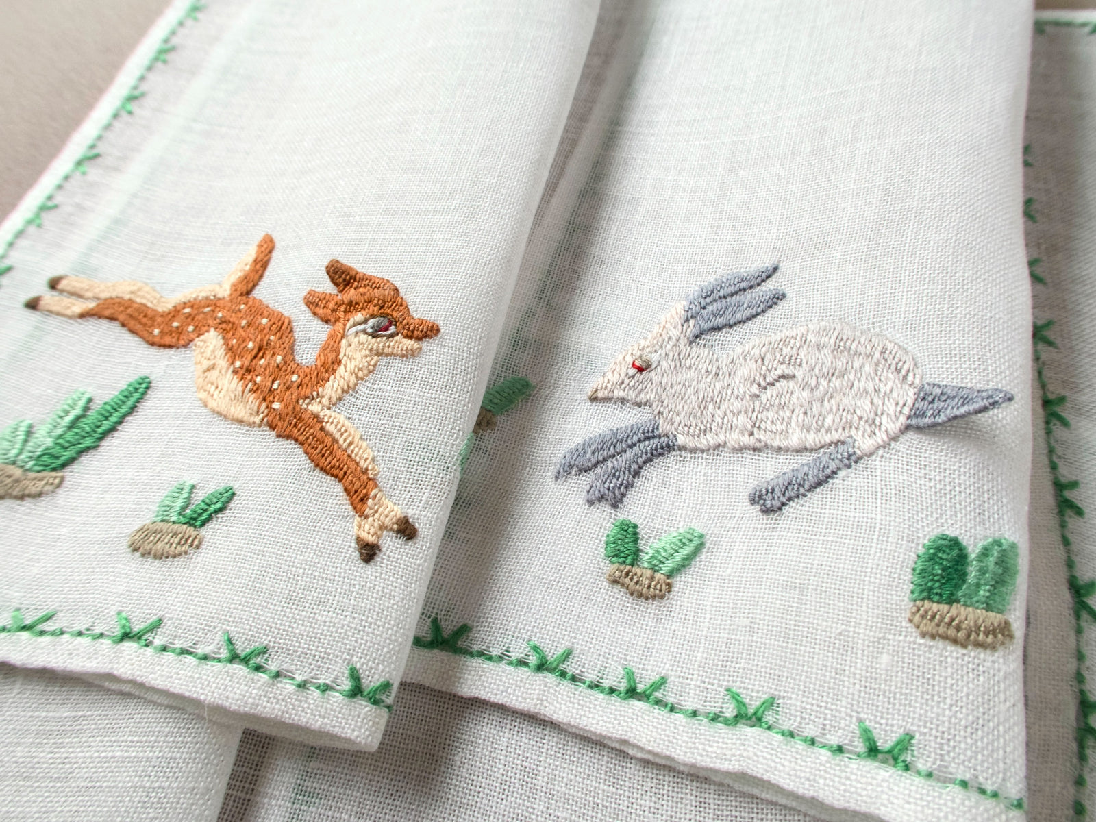 Vintage Rapisardi cocktail napkins with embroidered deer and rabbit with landscape details.