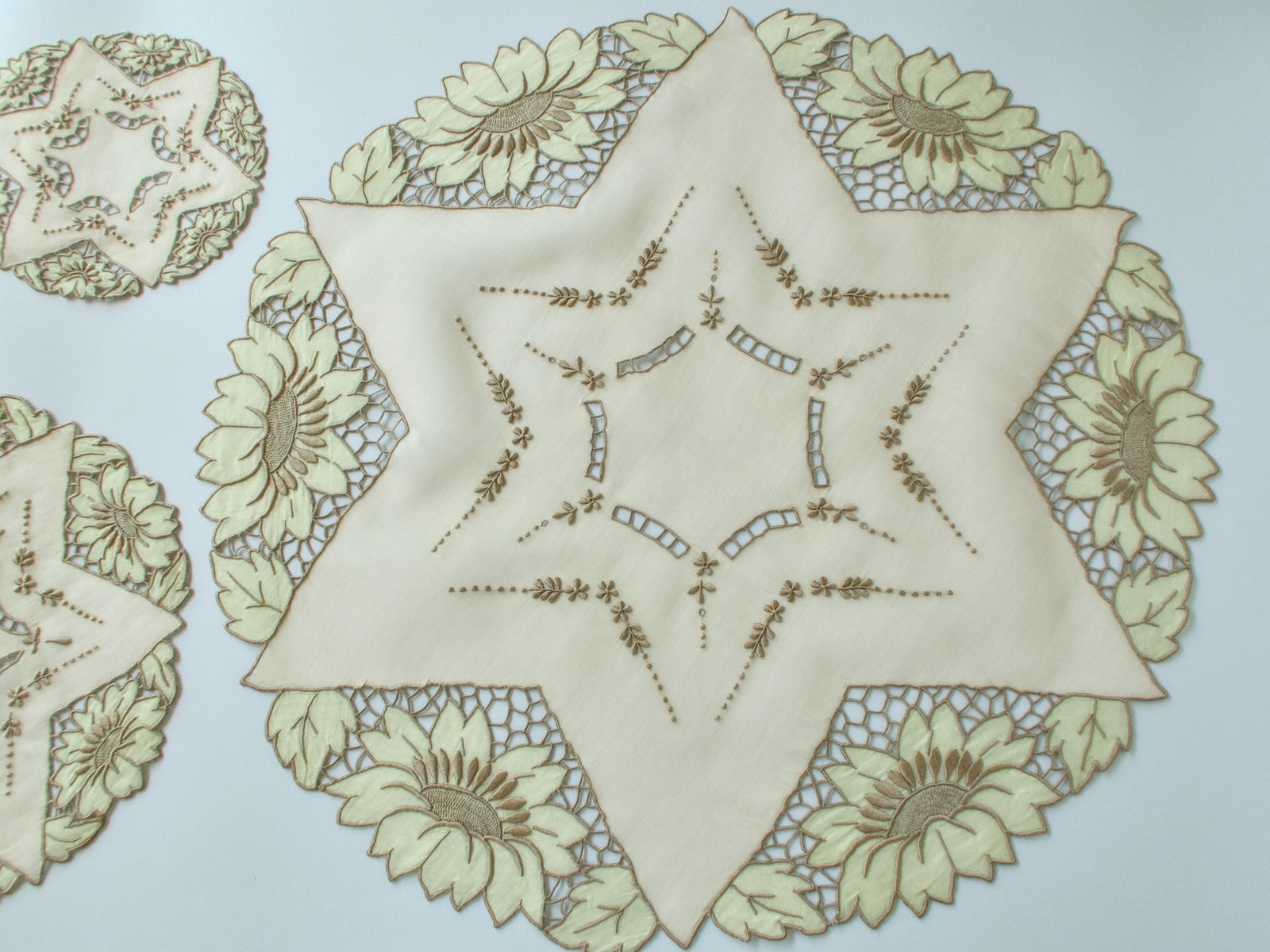 Vintage Madeira star-shaped organdy centerpiece with placemat and coaster showing intricate interior embroidery and sunflower appliqué border detail