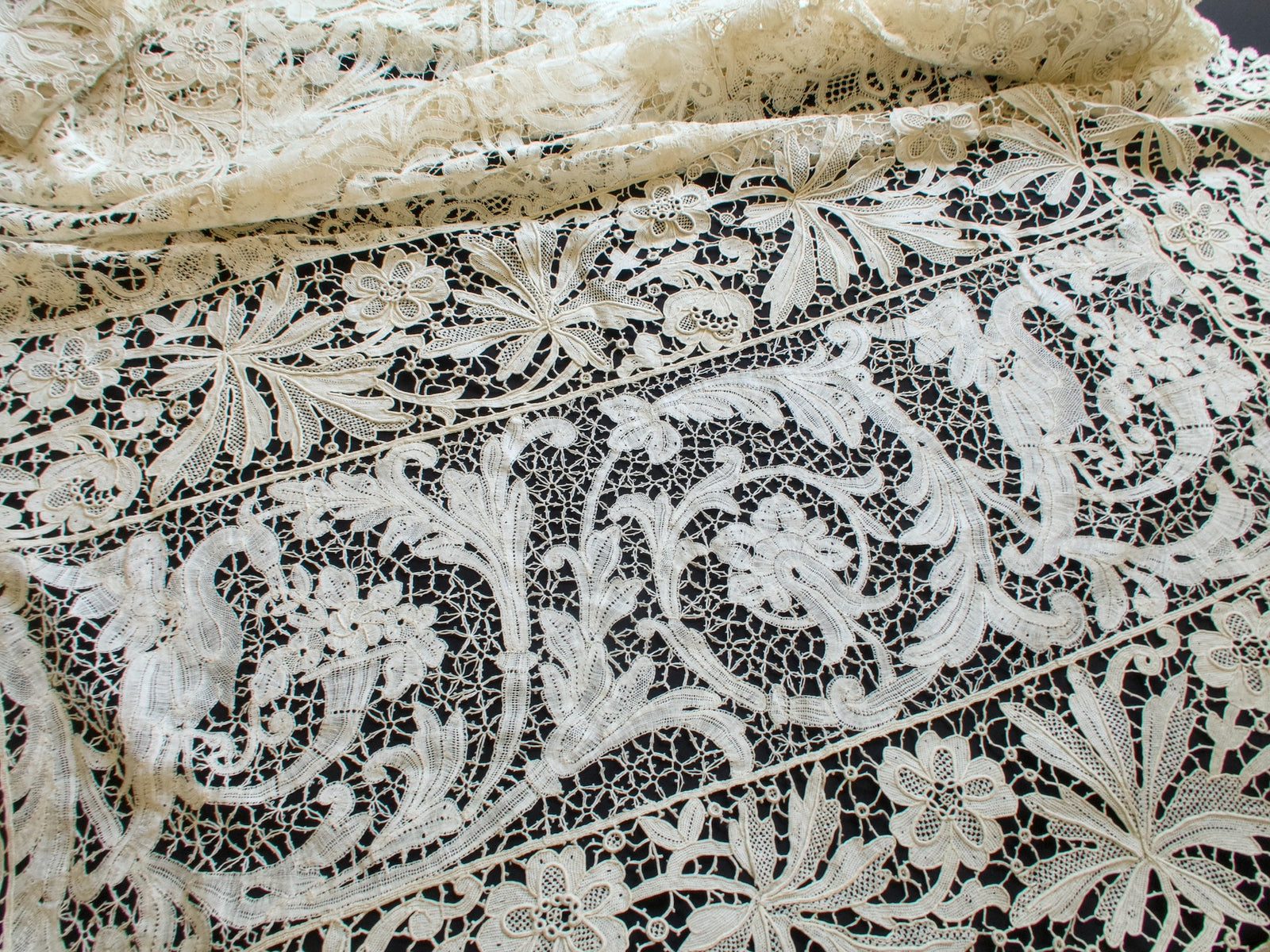 Antique French mixed lace tablecloth corner with a crane panel, floral medallions and a scalloped lace border