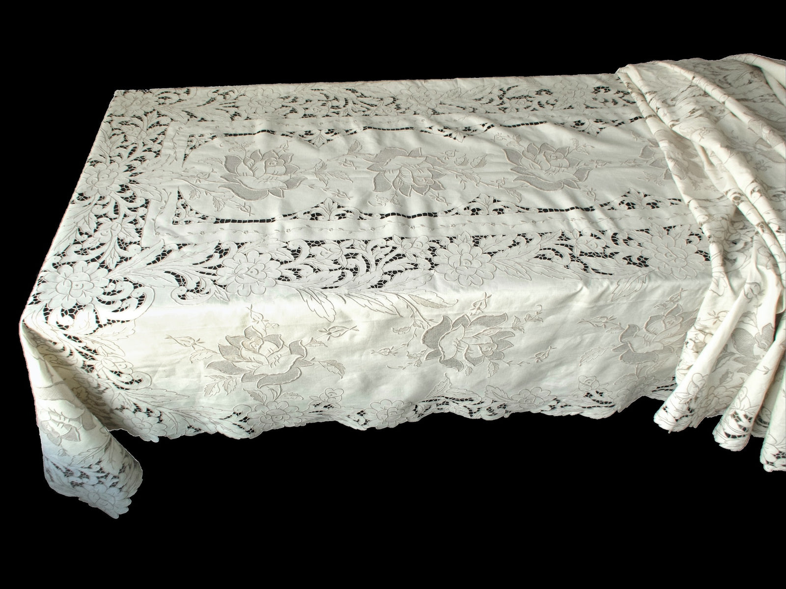 Corner of large Madeira tablecloth showing dense floral embroidery and intricate connecting bars.