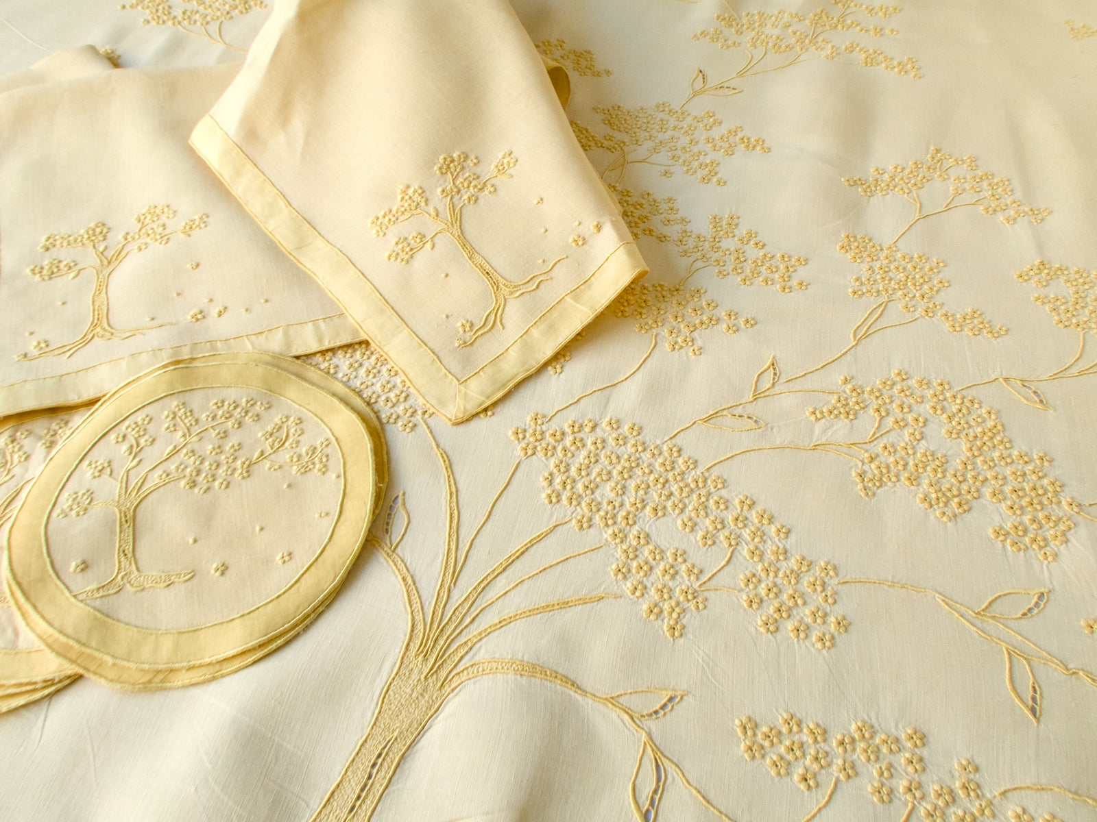 Close-up of Jacaranda Tree embroidery on yellow linen Marghab tablecloth