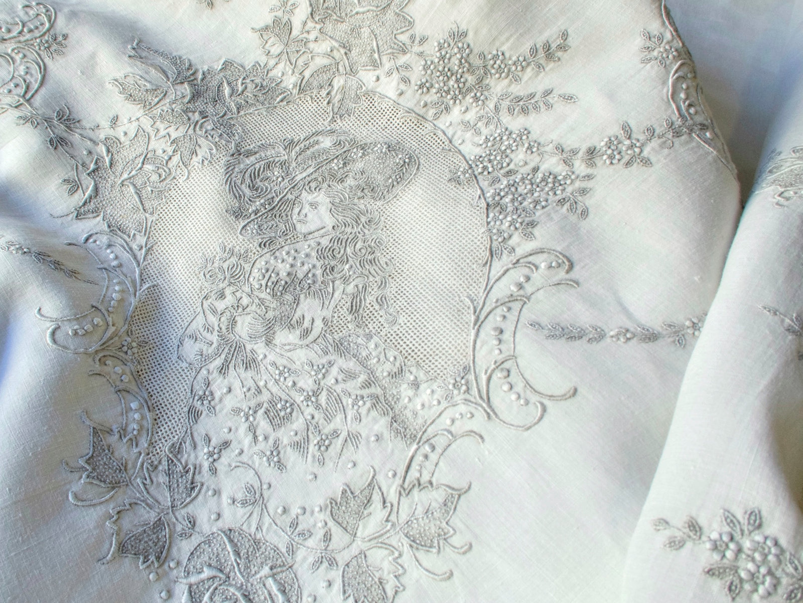 Vintage Swiss Appenzell tablecloth with ladies in period dress embroidered in pale gray on creamy white linen