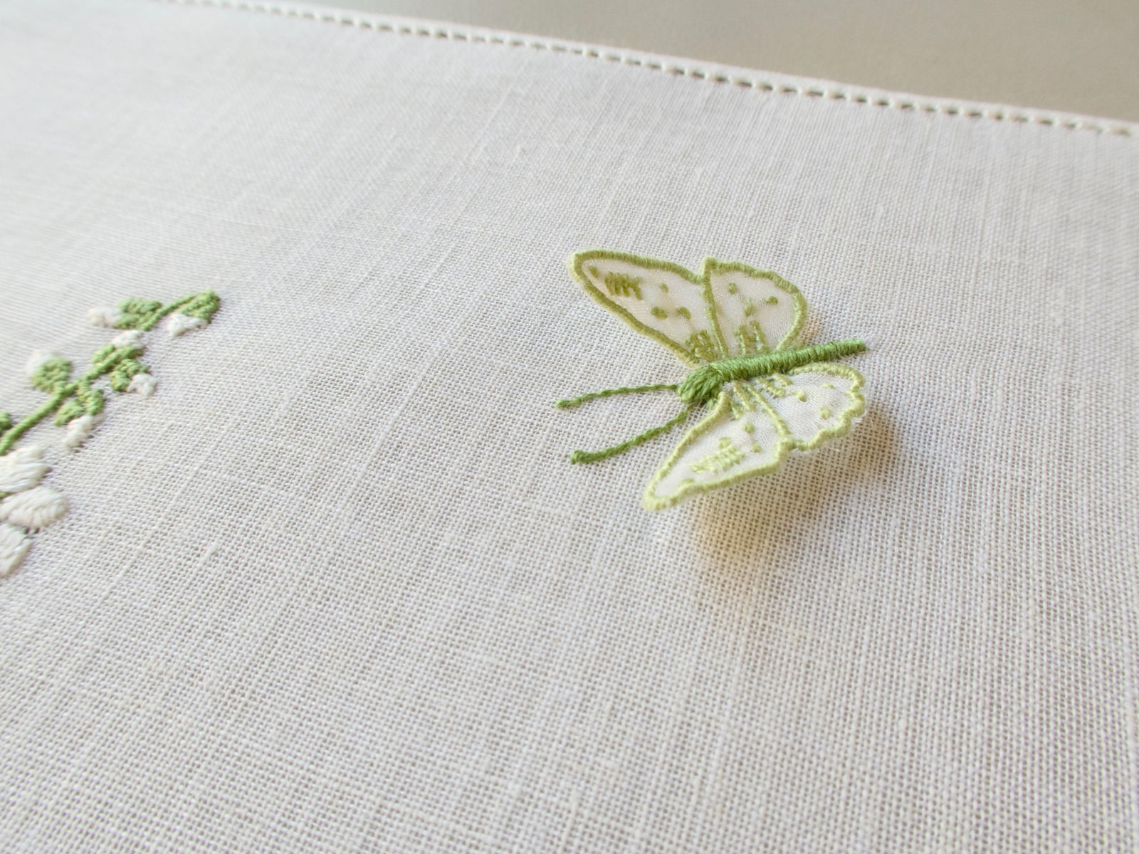 Detail of trembler butterfly and delphinium embroidery on vintage Rapisardi semi-sheer Italian linen tray cloth