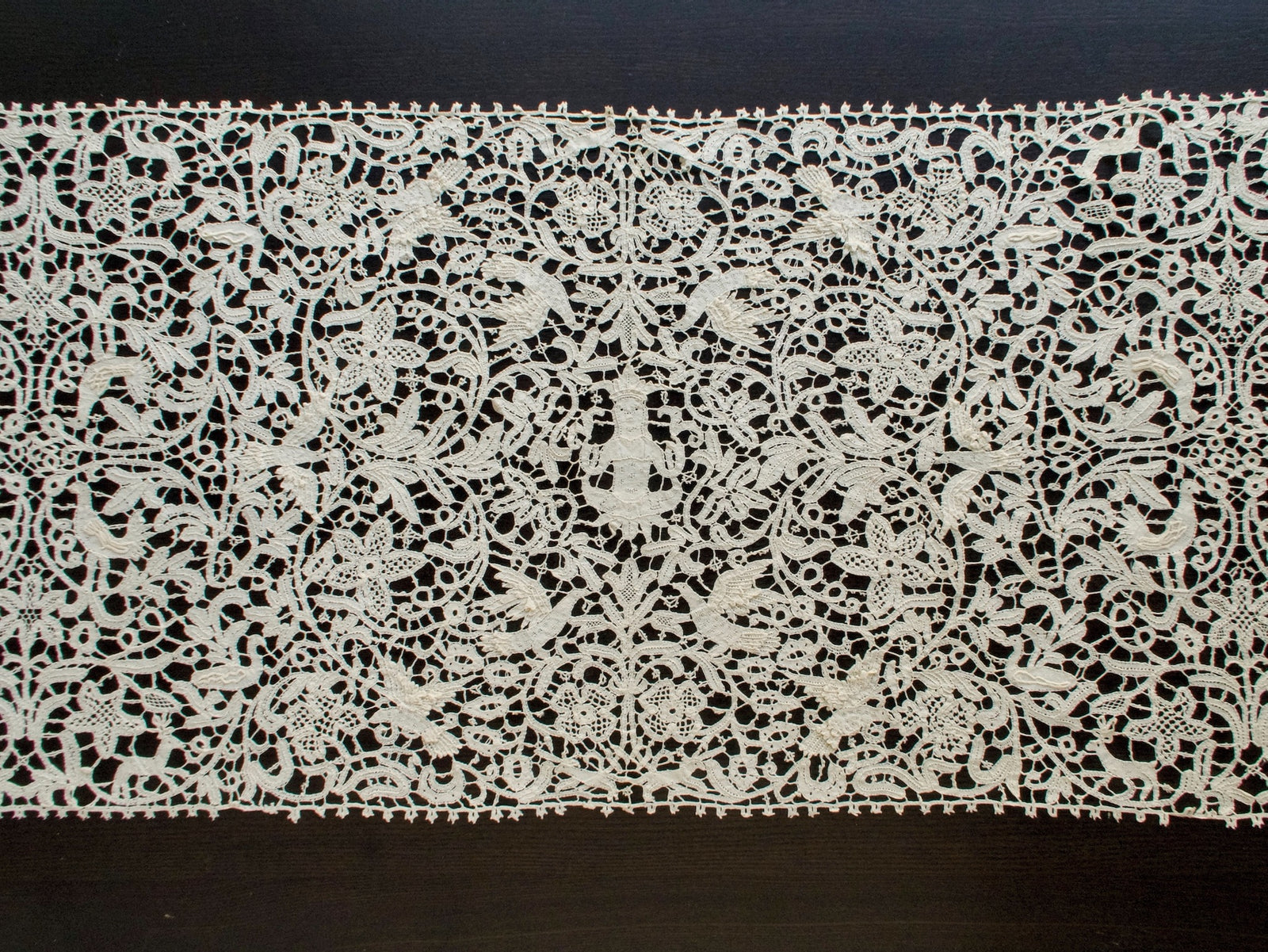 Vintage Italian bobbin lace runner featuring animals, birds and figures.