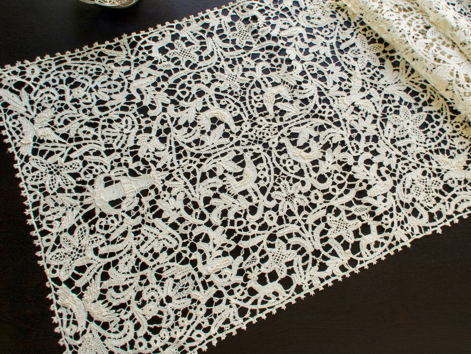 Vintage Italian bobbin lace runner featuring animals, birds and figures.