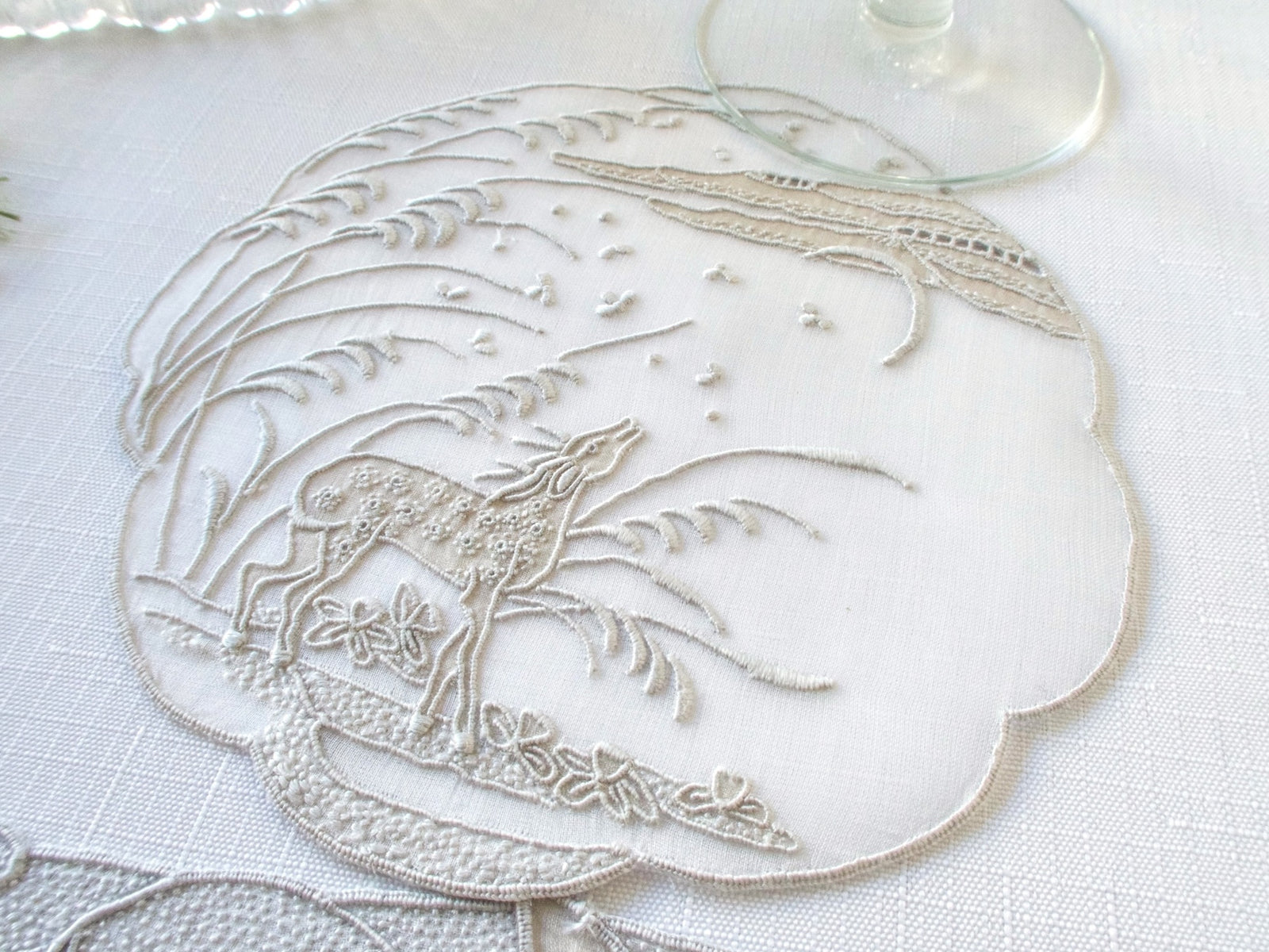 Vintage Marghab “Deer” pattern organdy coaster showing corner border detail with scrollwork and floral motifs.