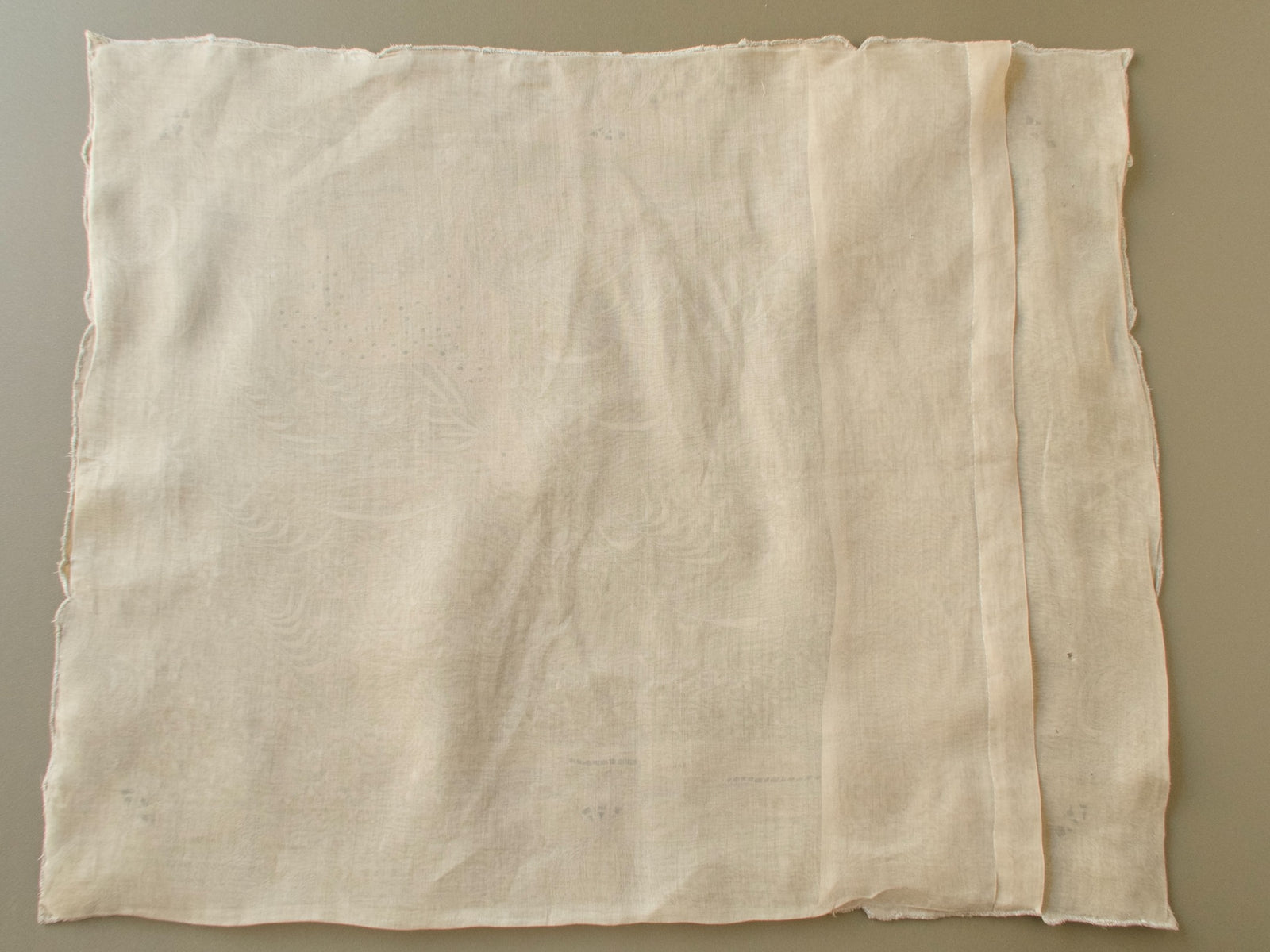 Back of a vintage Marghab "Deer" organdy pillow cover showing the sheer organdy and overlapping back opening