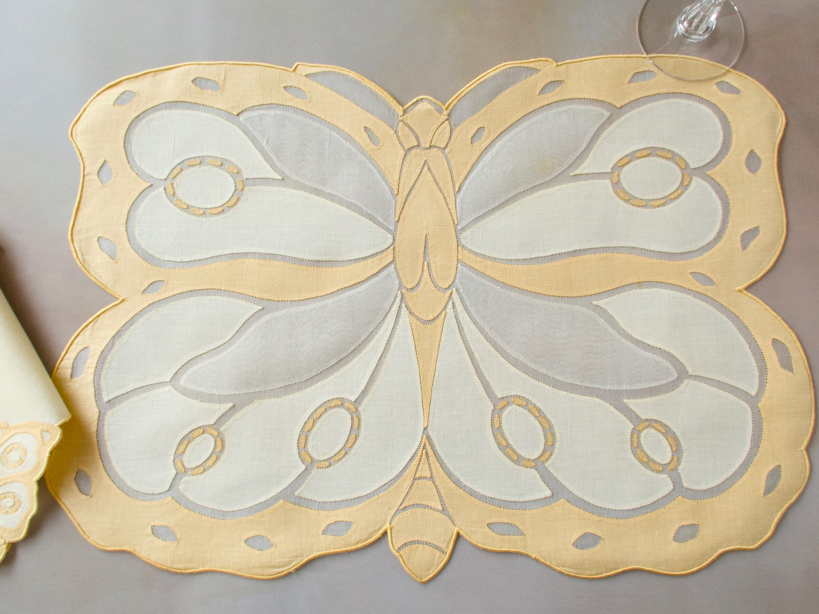 Vintage Madeira placemat shaped as a dimensional butterfly, with organdy wings, linen panels and delicate appliqué work on pale yellow linen ground