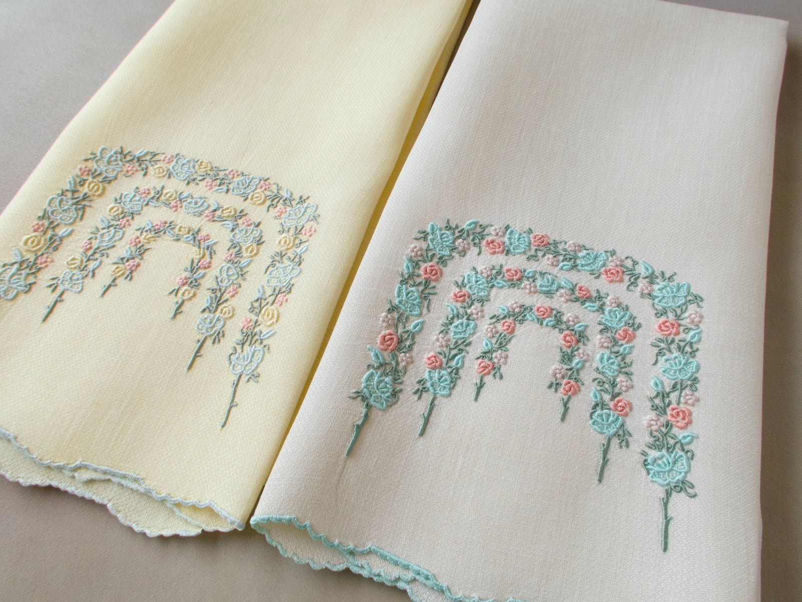 Two vintage Marghab Rose Arbor guest towels in complementary shades showing arched rose garland embroidery on huckaback linen.