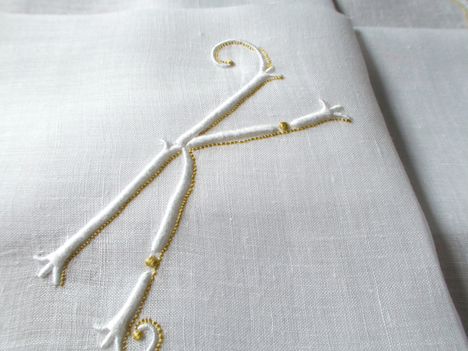 Vintage Marghab handkerchief in the “Initials” pattern, featuring a gold-embroidered “K” monogram with scalloped white border on fine linen. Hand embroidered in Madeira.