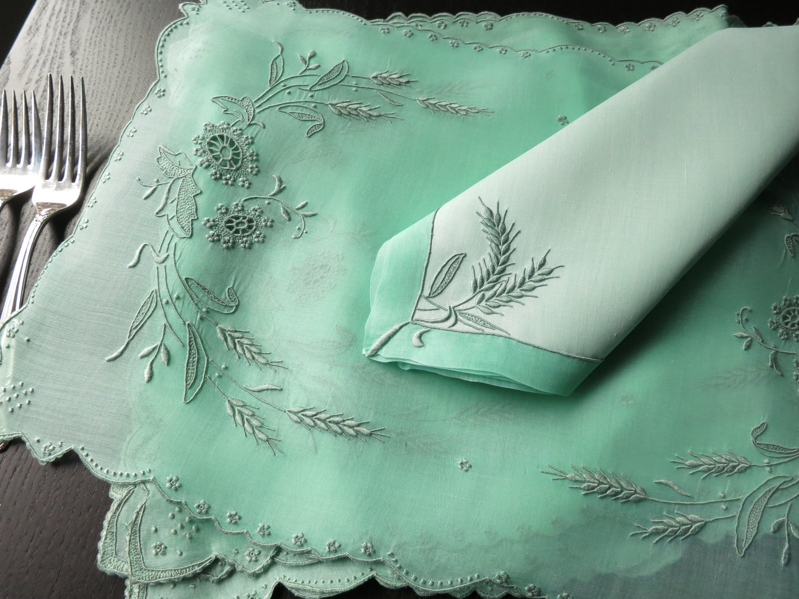 Stacked view of Marghab Wheat napkins showing fine embroidery and stitching.