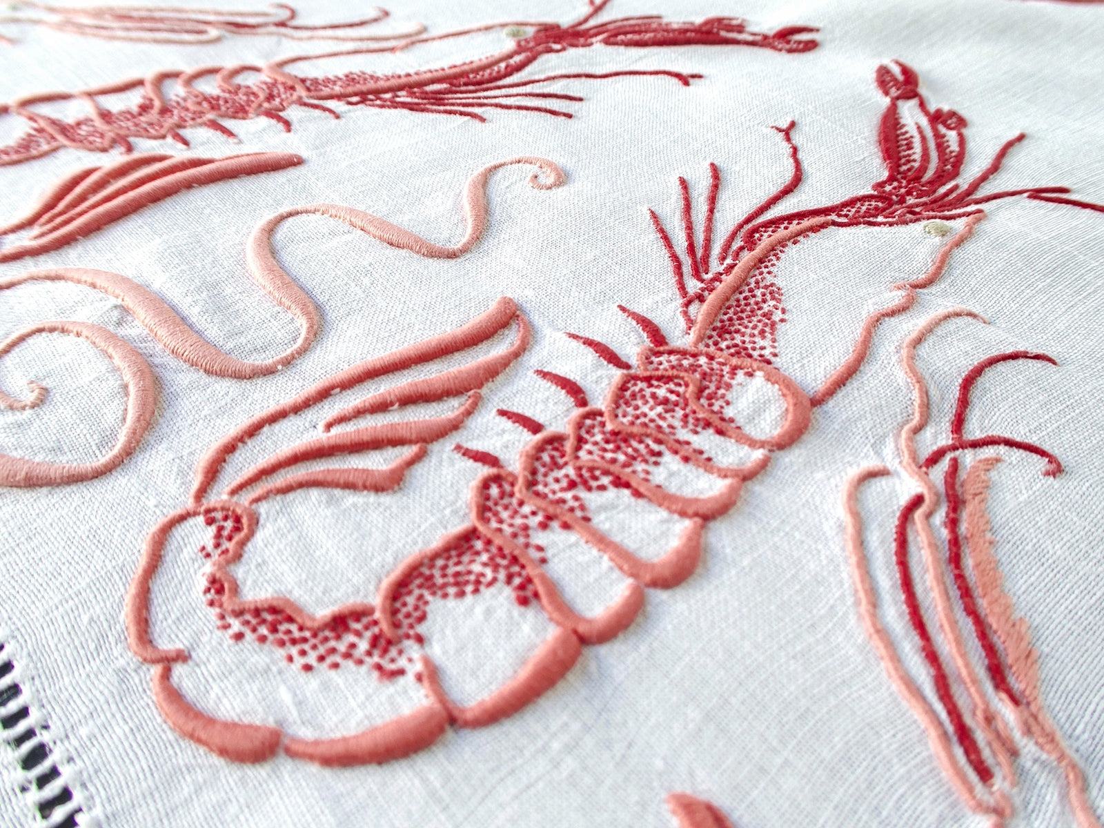 Antique French linen tablecloth & 8 napkins, hand embroidered with langoustines circa 1900. Extraordinary detail. Rectangular, 74×106”; napkins 29×29”.