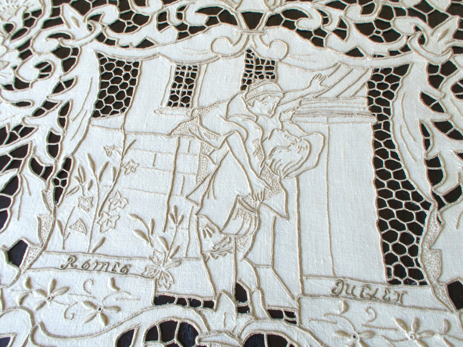 Vintage Madeira tablecloth with hand-embroidered Shakespeare scenes and Romeo & Juliet balcony motif.