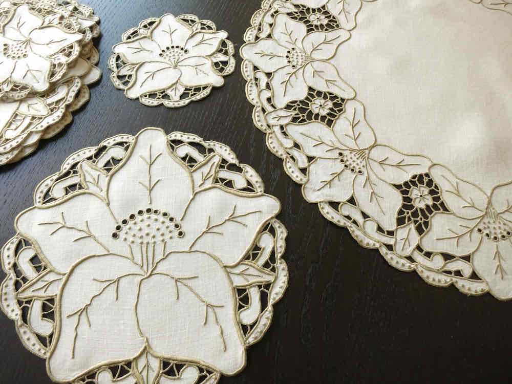 Vintage Madeira round placemat and coaster shown alongside centerpiece, Irish linen with embroidered hibiscus border