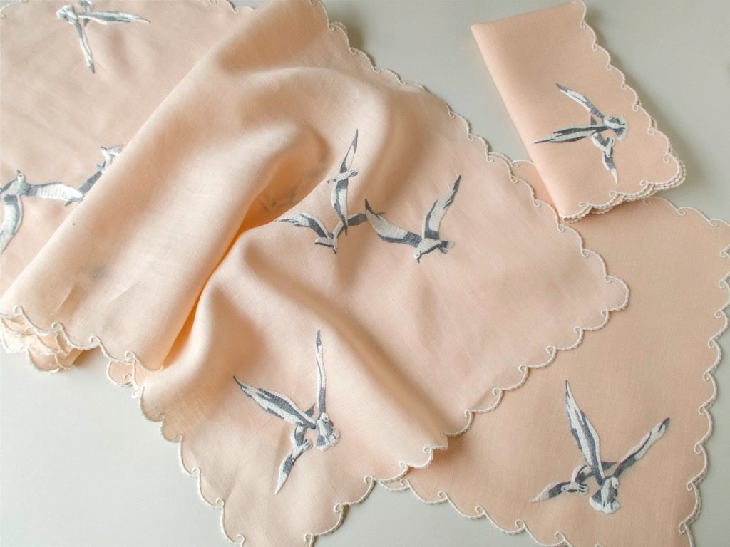 Vintage Madeira coral Irish linen table runner with hand embroidered seagulls in flight and wave motif border.