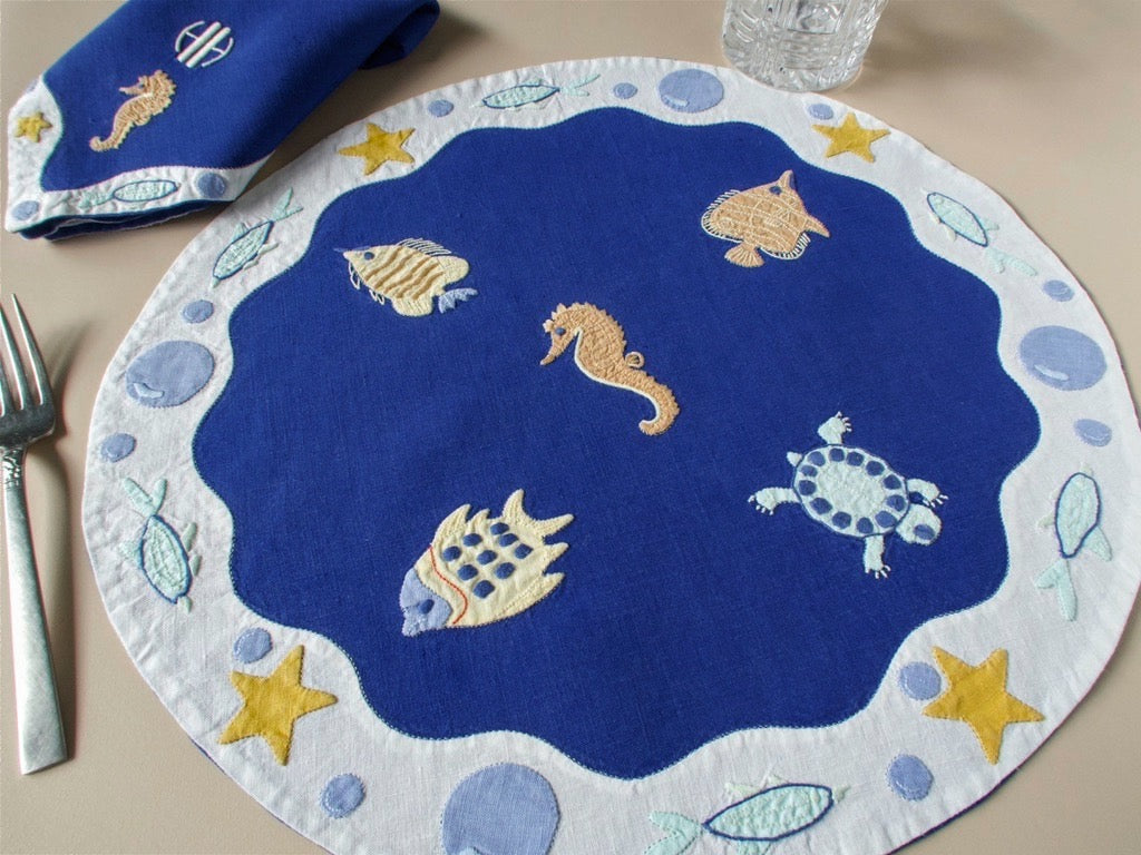 Vintage Léron placemat set for 8, deep blue linen with hand embroidered turtles, seahorses, starfish and fish, scalloped border, monogrammed napkins.