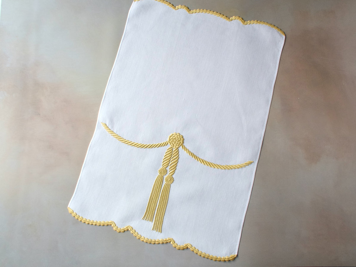 Vintage Marghab linen towel in the “Cord &amp; Tassel” pattern, hand embroidered in gold with twin tassels and scalloped edge.