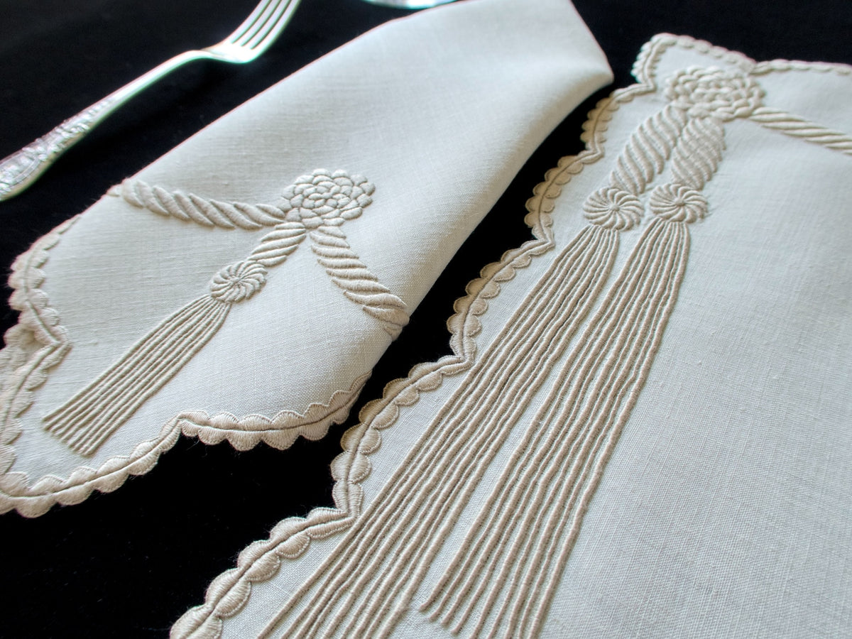 Vintage Marghab “Cord &amp; Tassel” placemat and napkin set, hand embroidered in Madeira on fine linen with intricate raised cord and tassel motifs in dimensional relief.