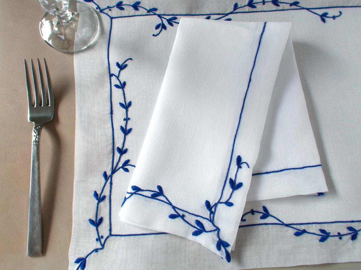 Vintage Marghab “Trailing Vine” placemat and napkin set, hand embroidered Madeira, blue on fine white linen with delicate vine borders.