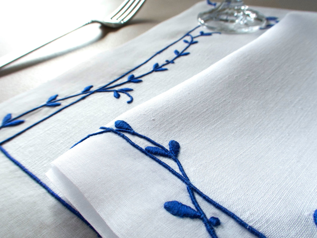 Vintage Marghab “Trailing Vine” placemat and napkin set, hand embroidered Madeira, blue on fine white linen with delicate vine borders.