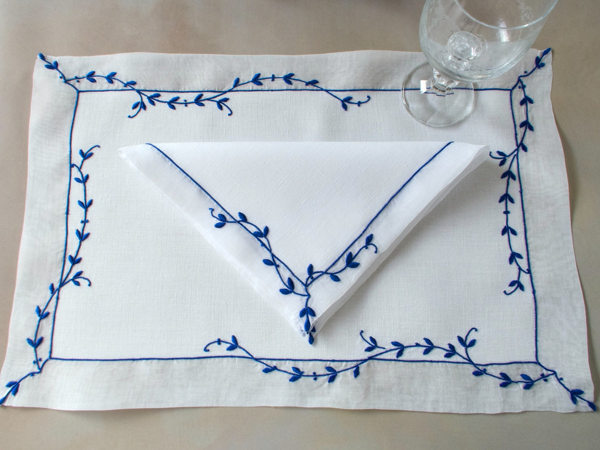 Vintage Marghab “Trailing Vine” placemat and napkin set, hand embroidered Madeira, blue on fine white linen with delicate vine borders.
