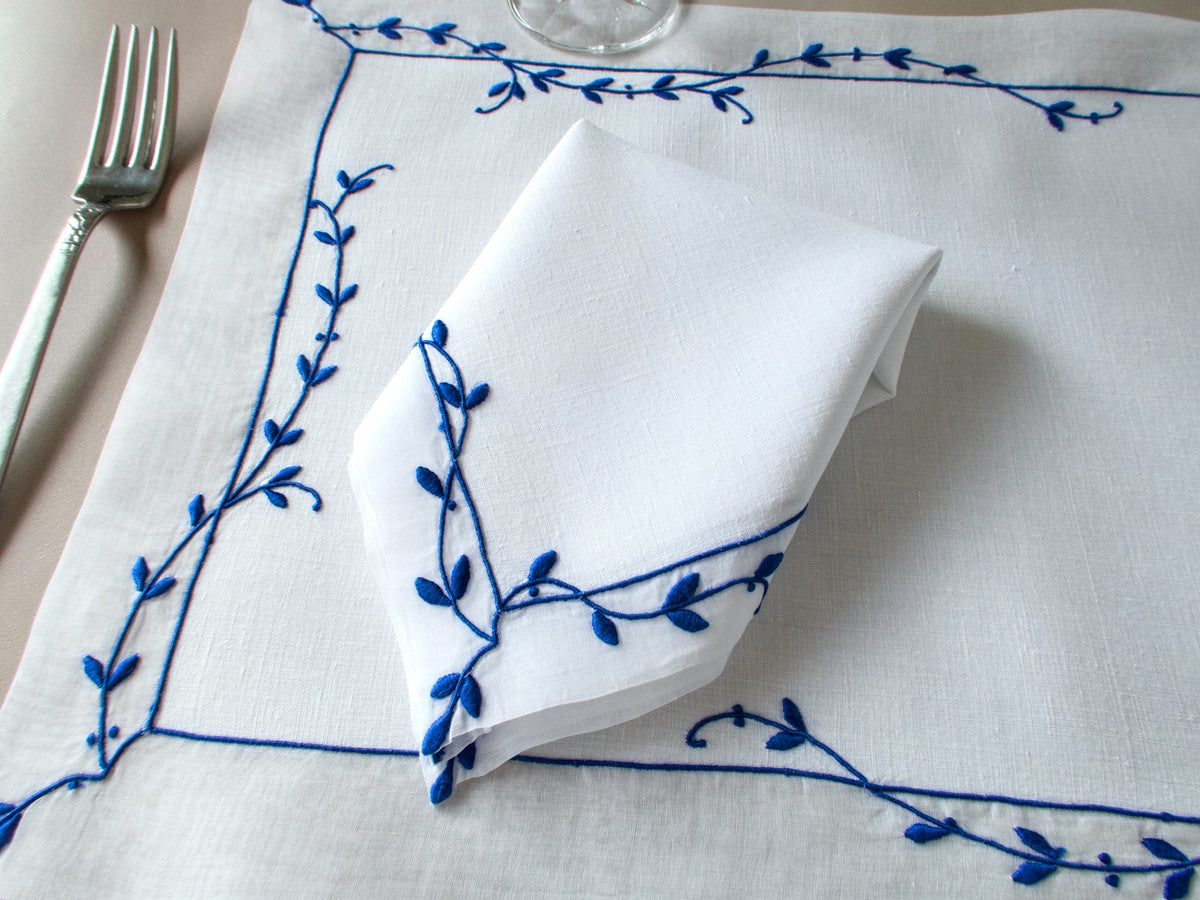Vintage Marghab “Trailing Vine” placemat and napkin set, hand embroidered Madeira, blue on fine white linen with delicate vine borders.