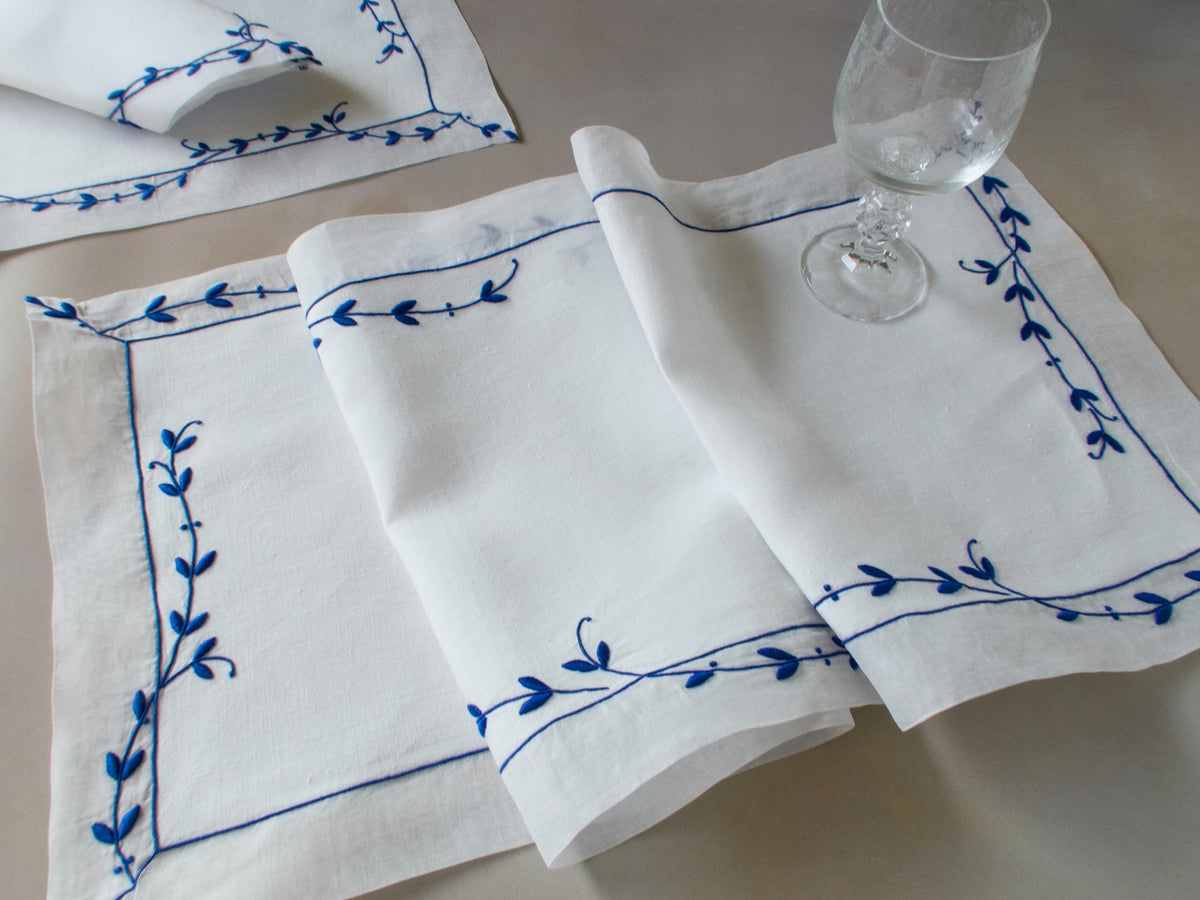Vintage Marghab “Trailing Vine” placemat and napkin set, hand embroidered Madeira, blue on fine white linen with delicate vine borders.