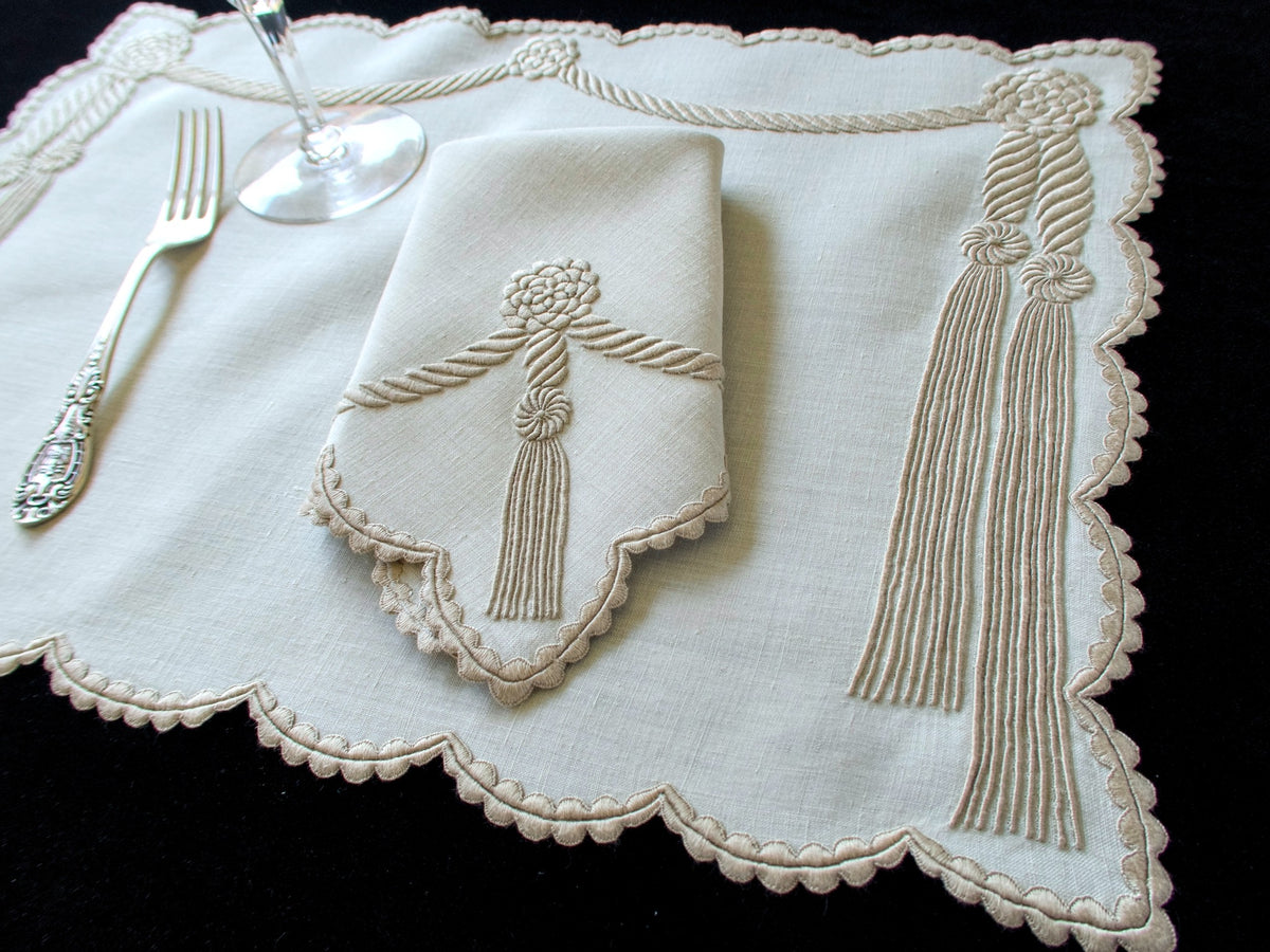 Vintage Marghab “Cord &amp; Tassel” placemat and napkin set, hand embroidered in Madeira on fine linen with intricate raised cord and tassel motifs in dimensional relief.