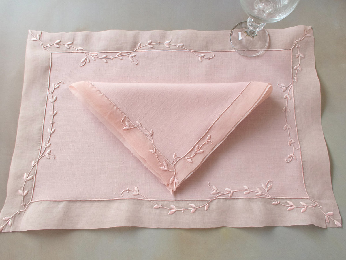 Vintage Marghab “Trailing Vine” placemat and napkin set in blush pink linen and organdy, hand embroidered in Madeira with delicate trailing vine motifs and double organdy borders.