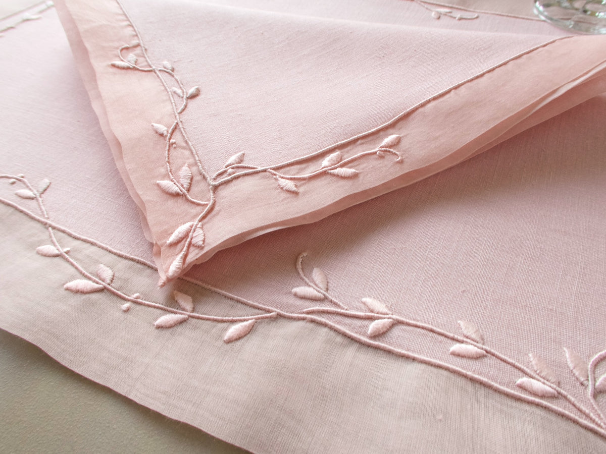 Vintage Marghab “Trailing Vine” placemat and napkin set in blush pink linen and organdy, hand embroidered in Madeira with delicate trailing vine motifs and double organdy borders.