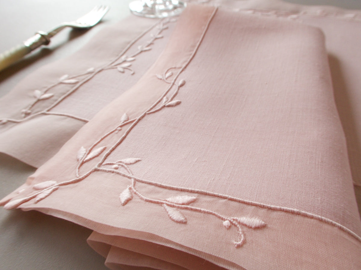 Vintage Marghab “Trailing Vine” placemat and napkin set in blush pink linen and organdy, hand embroidered in Madeira with delicate trailing vine motifs and double organdy borders.