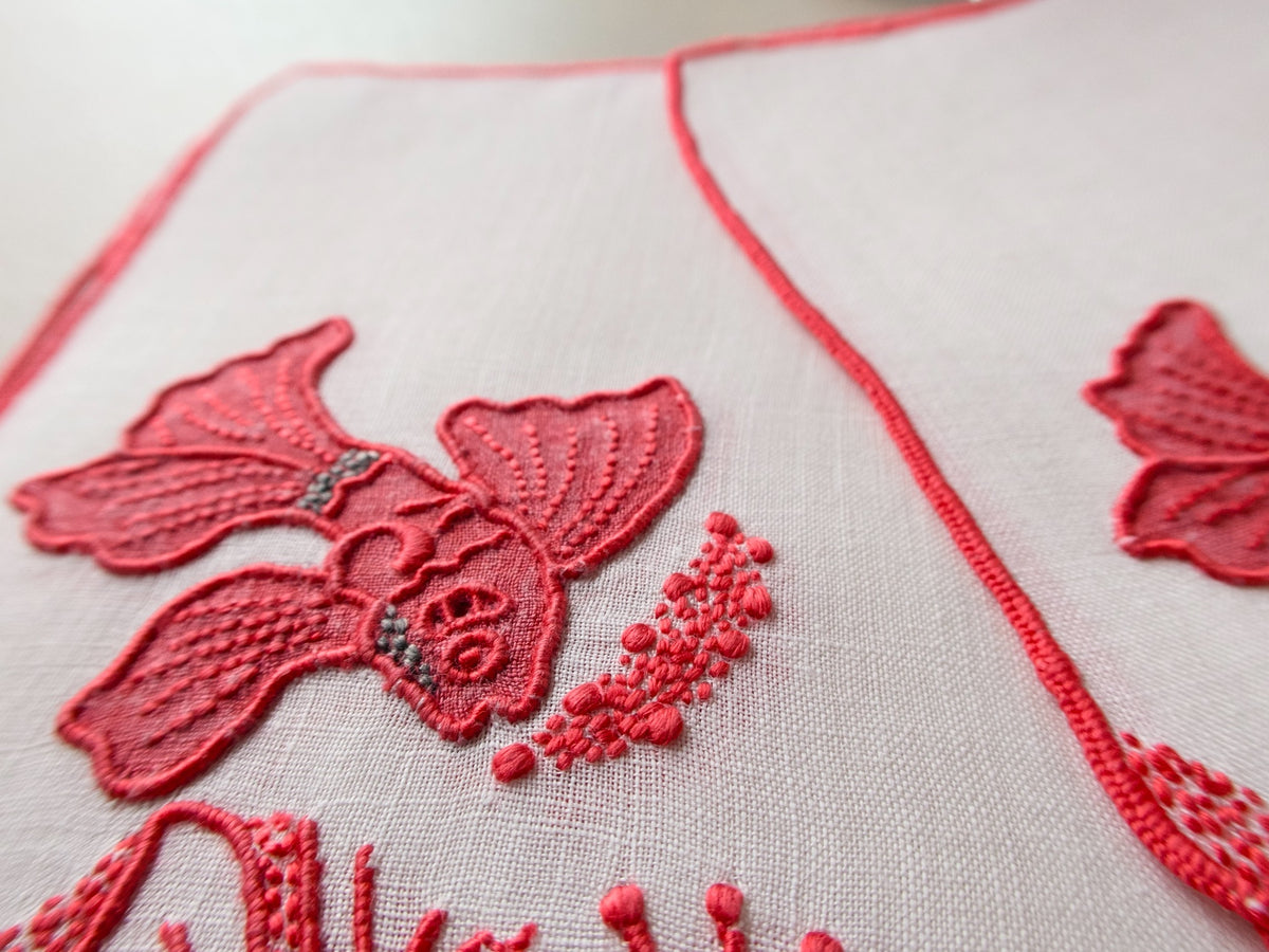 Detail of vintage Marghab Tropical Fish cocktail napkin showing extraordinary red embroidery and appliqué with coral and shell motifs​​​​​​​​​​​​​​​​
