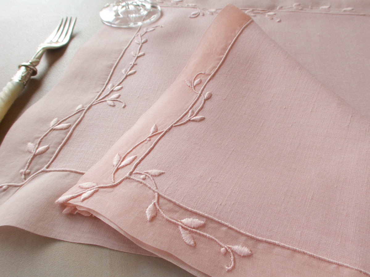 Vintage Marghab “Trailing Vine” placemat and napkin set in blush pink linen and organdy, hand embroidered in Madeira with delicate trailing vine motifs and double organdy borders.