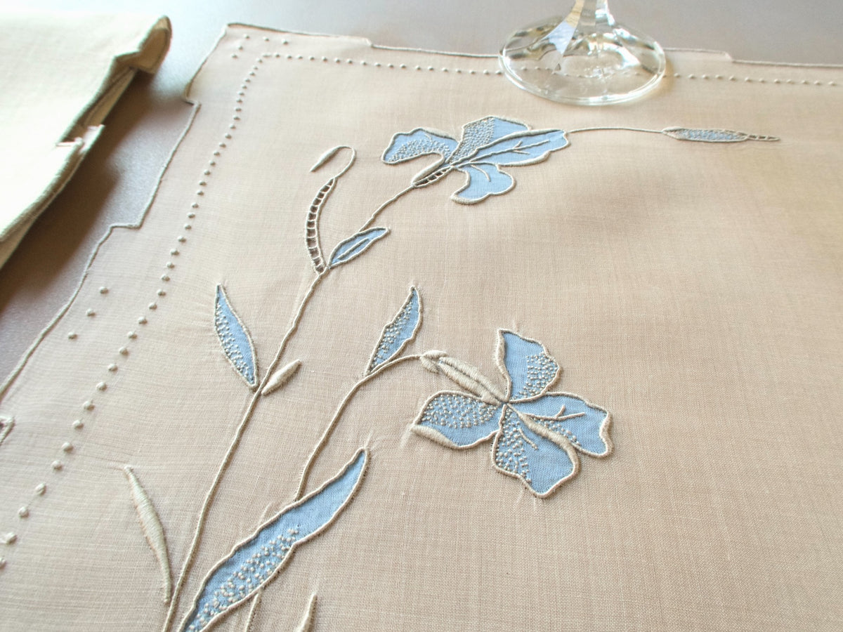 Vintage Marghab “Iris” placemat and napkin set in soft blue organdy and linen, hand embroidered in Madeira with layered appliqué iris blossoms and stepped hems.