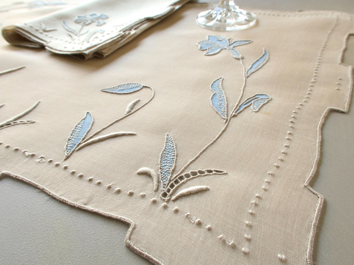 Vintage Marghab “Iris” placemat and napkin set in soft blue organdy and linen, hand embroidered in Madeira with layered appliqué iris blossoms and stepped hems.