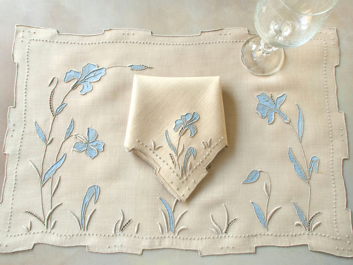 Vintage Marghab “Iris” placemat and napkin set in soft blue organdy and linen, hand embroidered in Madeira with layered appliqué iris blossoms and stepped hems.