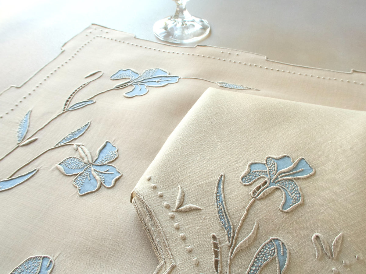 Vintage Marghab “Iris” placemat and napkin set in soft blue organdy and linen, hand embroidered in Madeira with layered appliqué iris blossoms and stepped hems.